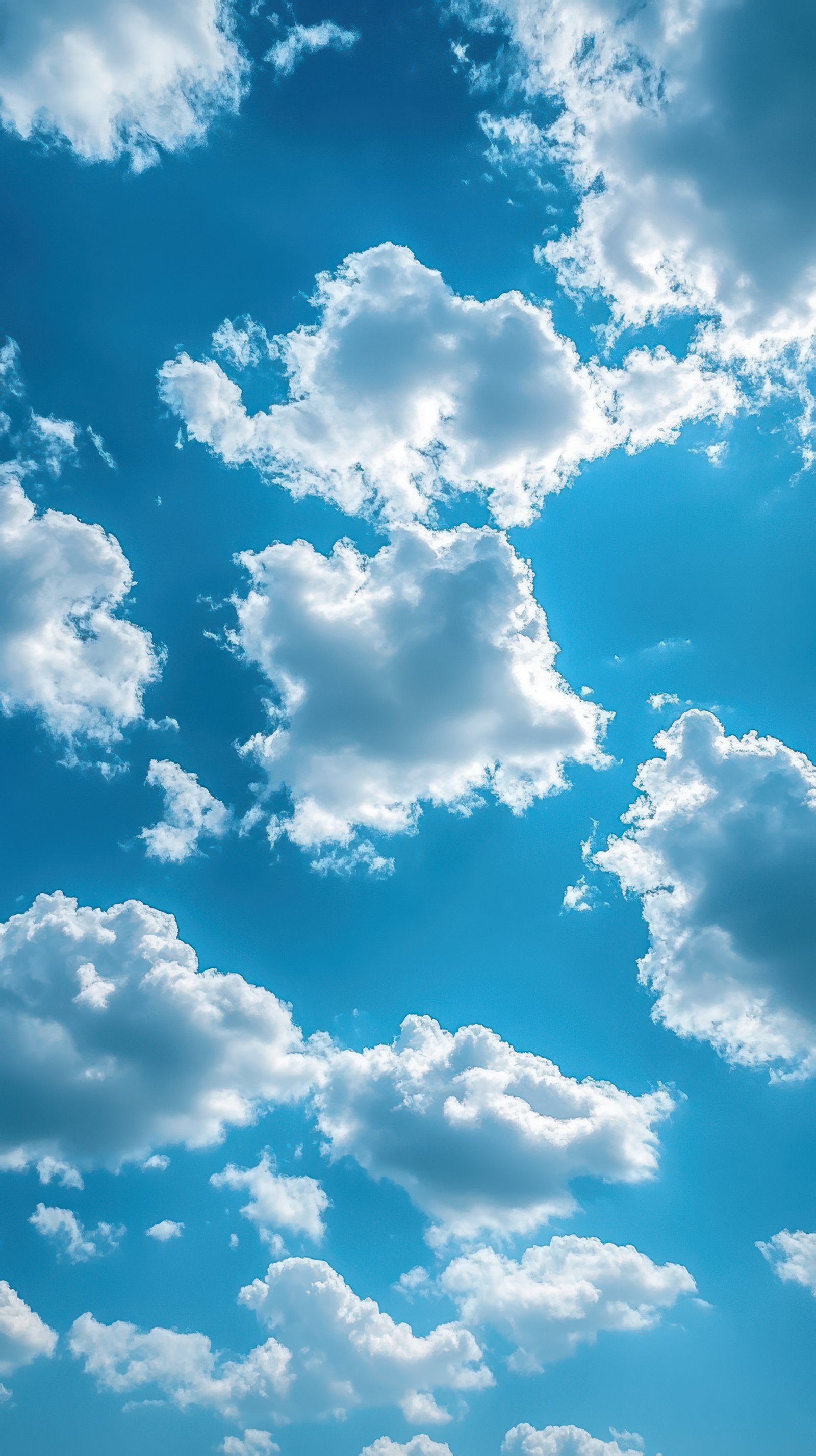 Bright blue sky filled with fluffy white clouds on a sunny day